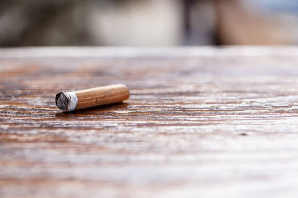 istock used cigarette on the wooden table. Selective and close focus 934098818