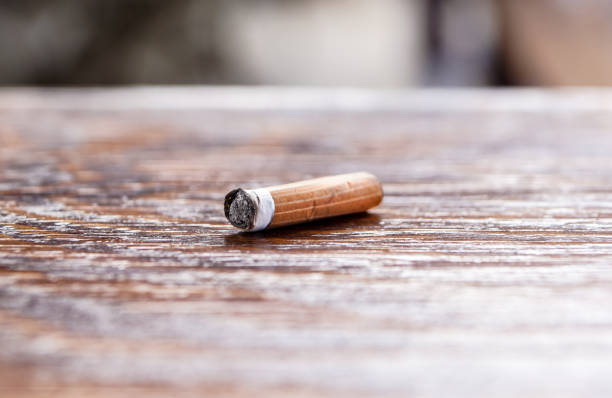 istock used cigarette on the wooden table. Selective and close focus 934098844