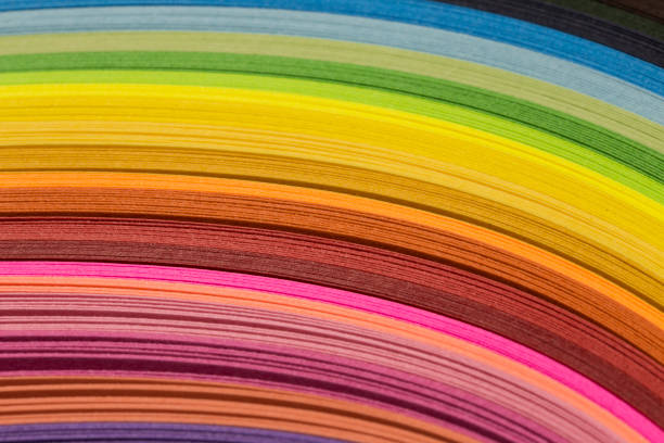 istock Multicolored quilling paper curved stripes forming a bright background. 934101572