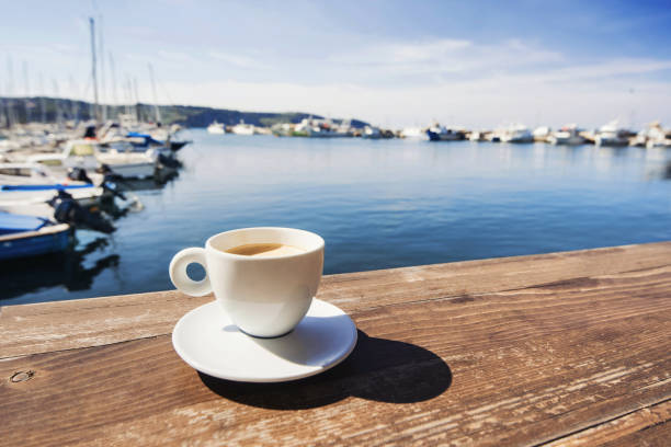 cup of coffee with a sea at the background - espresso table coffee cafe imagens e fotografias de stock