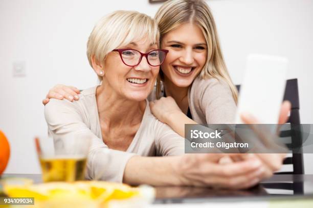 Senior Woman And Her Daughter Having Fun And Posing For A Selfie Stock Photo - Download Image Now