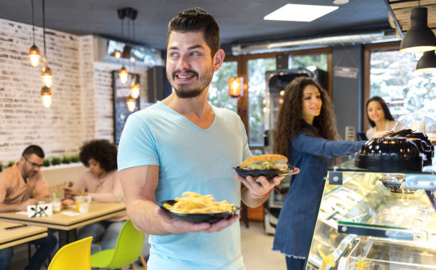 istock Man in front of showcase with fast food 934113900