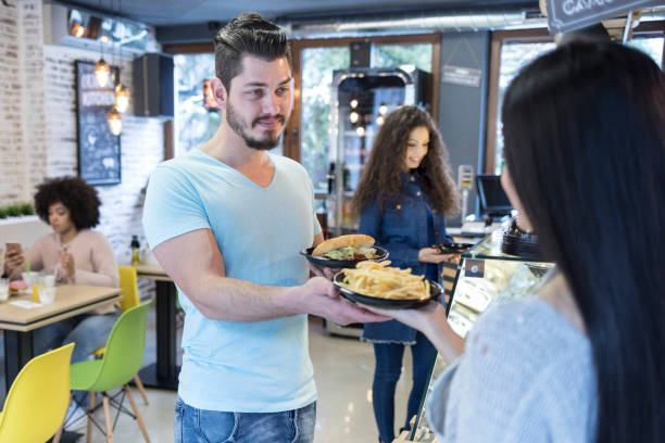 istock Man in front of showcase with fast food 934113928