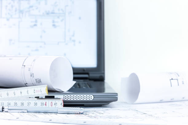 istock construction blueprints with laptop folding rule and pencil on wooden desk 934114142