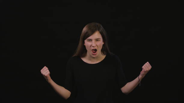 istock A Lady Shouting Against a Black Background 934122618