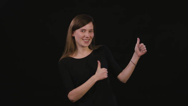 istock A Lady Mimicing Against a Black Background 934122822