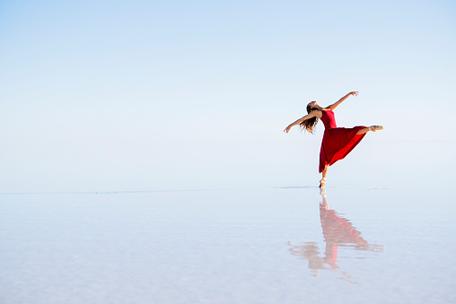 Beautiful ballerina dancing on the lake in the evening. Salt Lake in Anatolia - Turkey