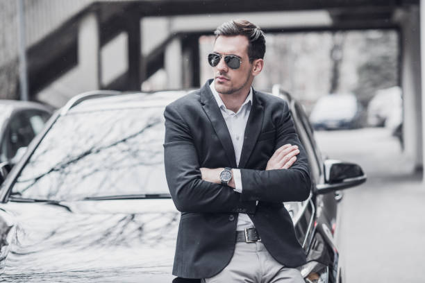 istock Young CEO waits next to car 934139058