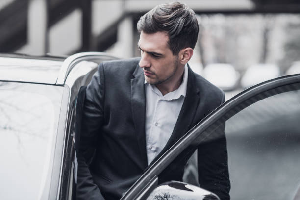 istock Handsome young CEO enters a business car 934139130