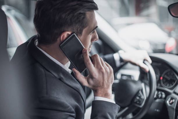 istock CEO talks on the phone in a business car 934141478