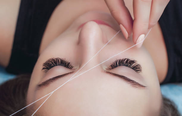 istock The make-up artist plucks her eyebrows with a thread close-up. 934141776