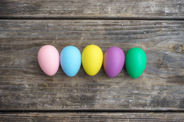 istock Row of colorful eggs on wooden table 934150582