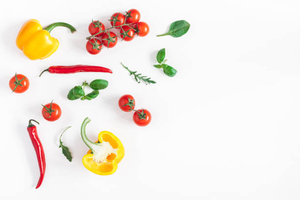 istock Tomatoes, peppers, green leaves. Flat lay, top view, copy space 934158376
