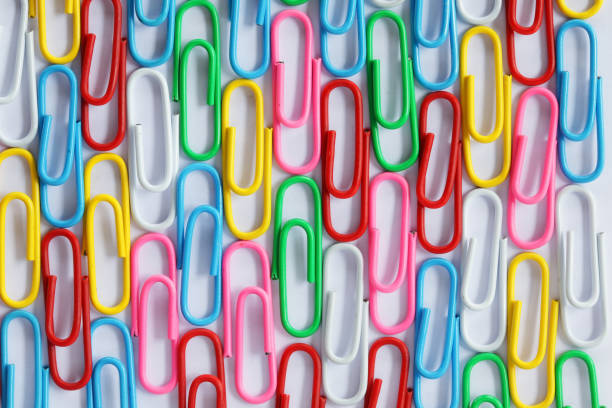close up stack of colorful paper clip on white background
