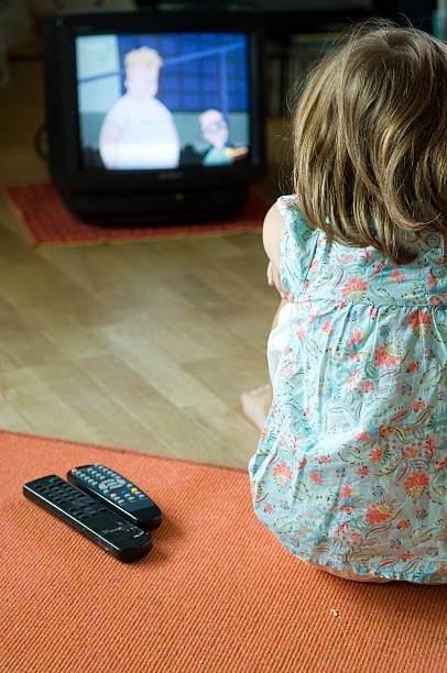 istock little girl is watching tv 93420638