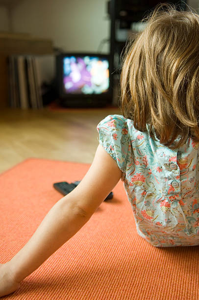 istock cute little girl watching television. 93420925
