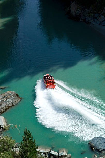 Cancun. Mexico. 04.28.2025. Jet ski rides across turquoise Caribbean Sea leaving white trail, view from above in Cancun.