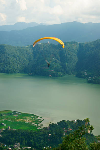 istock Scenic view at Pokhara lake mountain range and paraglider 934220494