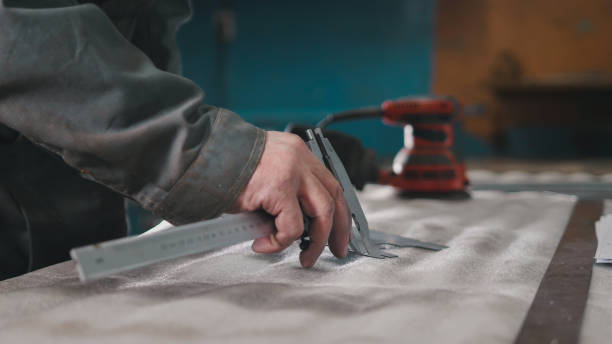 istock Worker making measurements and marks on the metal part using a caliper 934221068