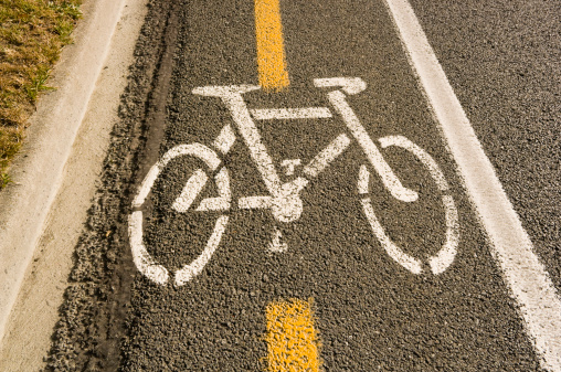 Aerial view of a concrete bike path with adjacent vehicle tire tracks