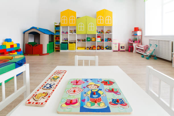 istock Desk for classes in bright white game room in the kindergarten 934230610