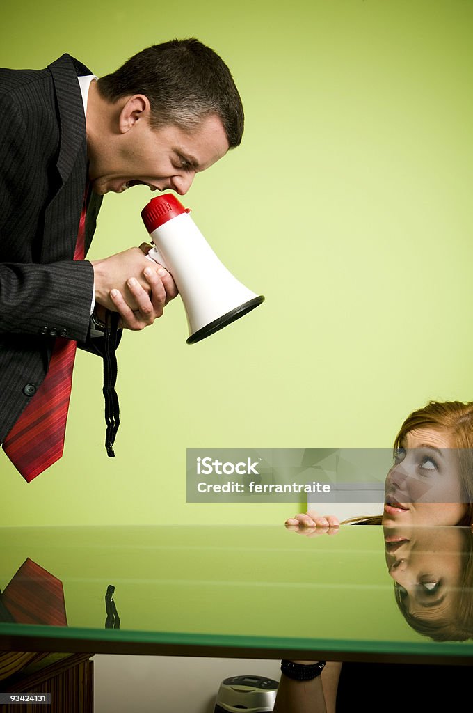 Quarrel Angry boss quarreling his assistant with a megaphone. Megaphone Stock Photo