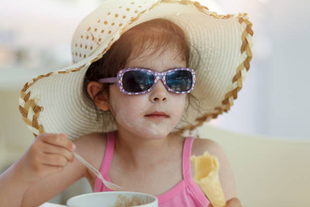 Little girl with sun protection cream