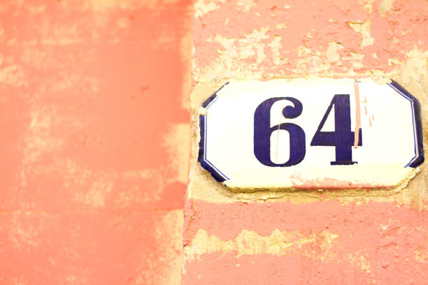 istock Italy: Ceramic Number 64 Street Address Tile; Pink Wall 934245332