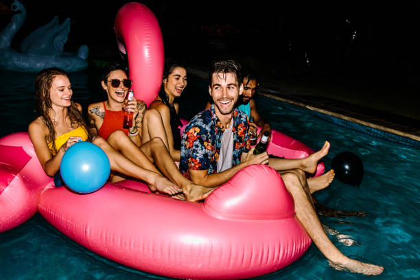istock Friends hanging out at evening pool party 934251604