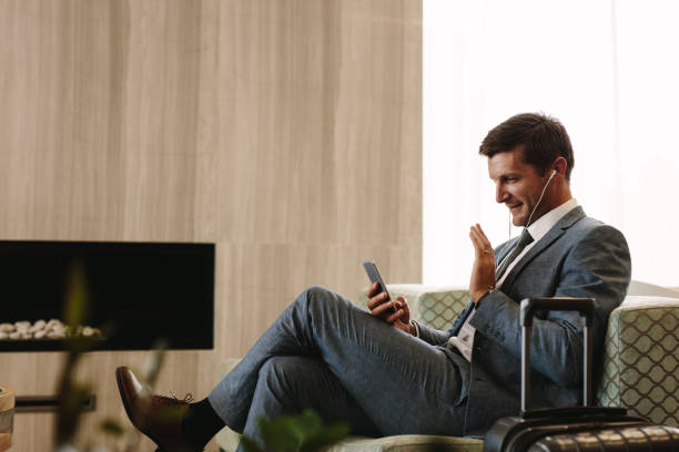 istock Businessman making a video call while waiting for his flight 934251724