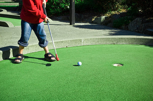 istock Child putting ball on miniature golf course 93425177