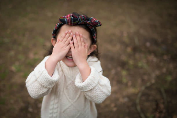istock Little girl hiding her face with hands 934252356