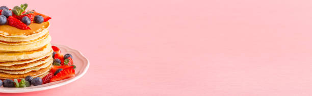 istock Pancakes with berries on a bright pastel background 934255652