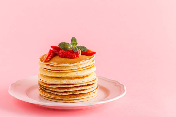 istock Pancakes with berries on a bright pastel background 934255656
