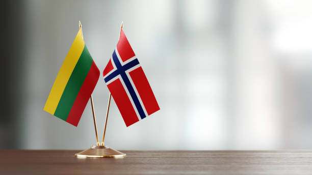 istock Lithuanian And Norwegian Flag Pair On A Desk Over Defocused Background 934256526
