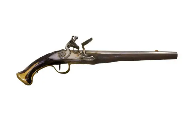 Closeup of 18th century firearms, pistol or musket with wooden handle and bronze rim, isolated on white background.