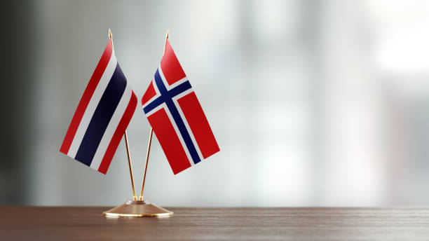 istock Thai And Norwegian Flag Pair On A Desk Over Defocused Background 934259410
