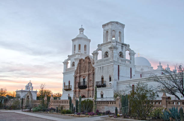 San Xavier del Bac Mission at Sunset The San Xavier del Bac Mission stands on the Tohono O'odham Indian Reservaton near Tucson, Arizona. tohono o'odham stock pictures, royalty-free photos & images