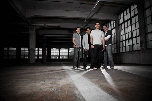 A group of five friends having fun in an indoor setting with warm and stylish lighting, creating a lively atmosphere full of excitement and togetherness.