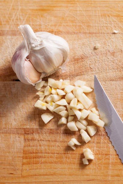 istock Sliced garlic on a wooden old kitchen Board 934268278
