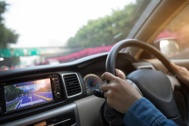 istock Hands on wheel driving car in city 934268384