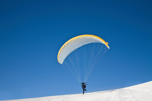 One random person is paragliding in Dachstein, Hallstatt with beautiful mountain and sky background