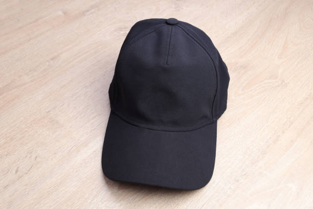istock Black cap on wooden background 934283316