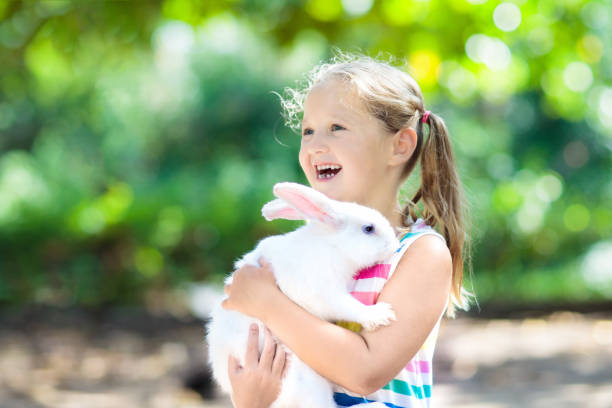 istock Child with rabbit. Easter bunny. Kids and pets. 934289912