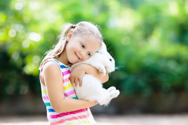 istock Child with rabbit. Easter bunny. Kids and pets. 934290128