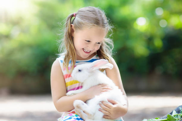 istock Child with rabbit. Easter bunny. Kids and pets. 934290286