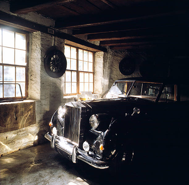 istock Old black car parked in stone garage with windows 93429175