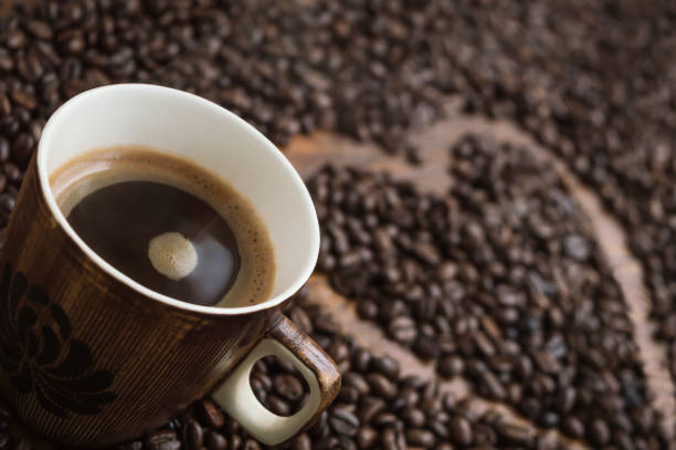 istock cup and coffee beans isolated on an blurred background 934292654