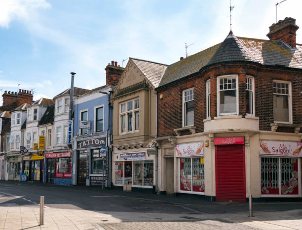 A parade of small shops in Suffolk Road, a side street off the main London Road in Lowestoft, Suffolk, Eastern England. It contains the usual mixture of retail establishments, including a convenience store, nail bar, tattoo parlour, IT shop, fish and chip shop etc.