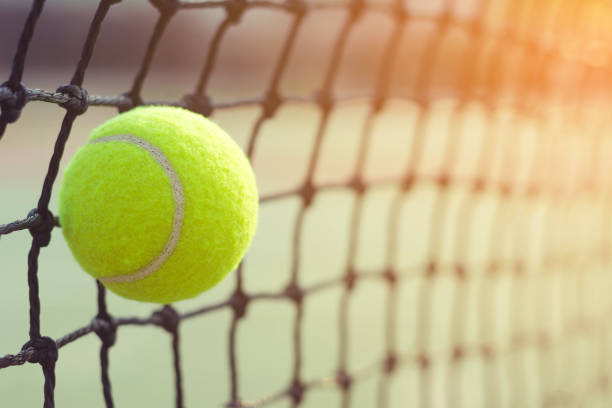 istock Close up tennis ball hitting to net on blur background 934292688